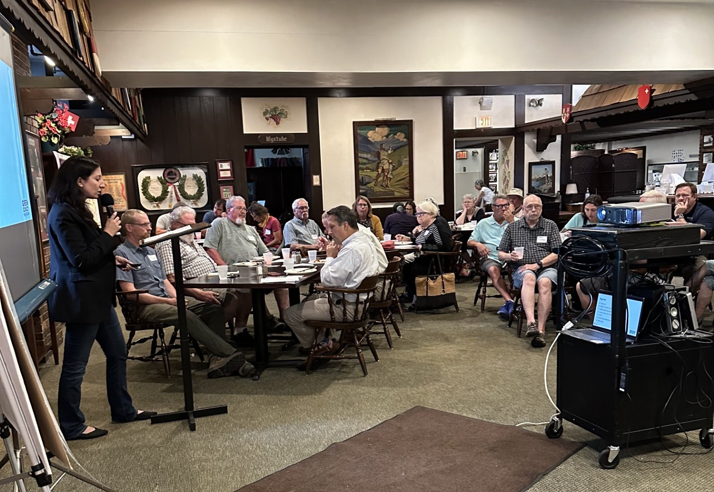 room with people listening to presentation
