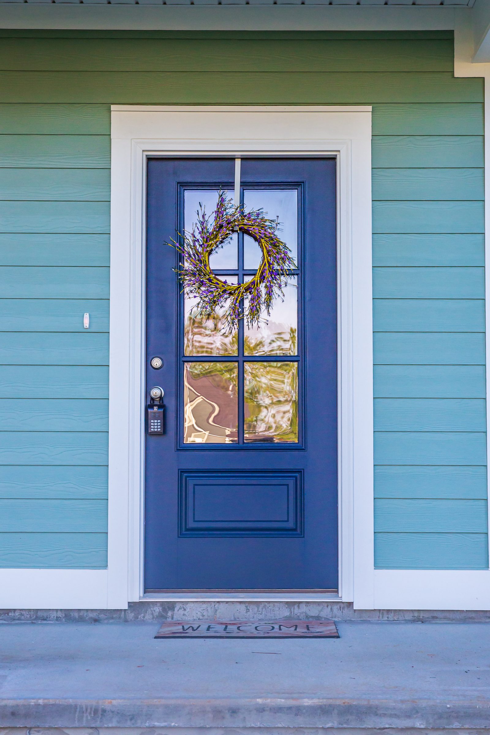 A blue exterior door with a wreathe